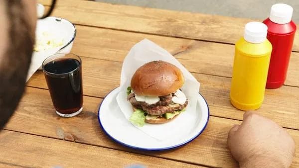 Burger and drink on a picnic table