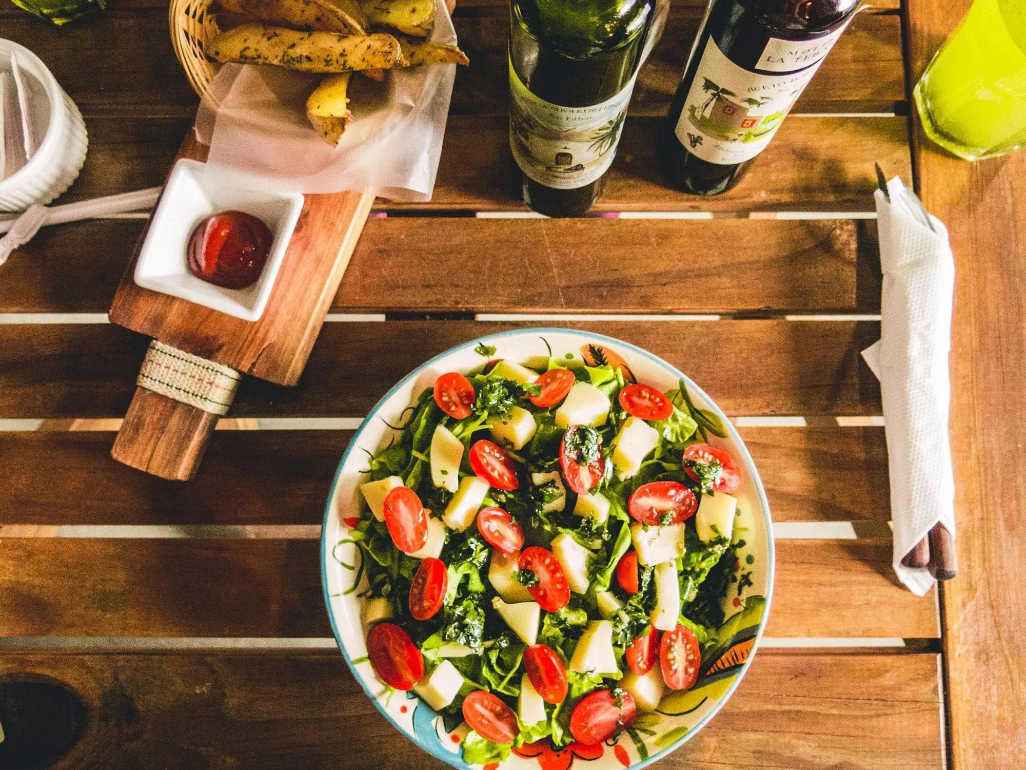 Salad and potato wedges wine dinner